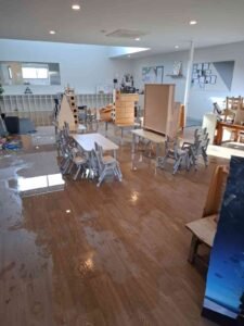 Geelong childcare centre floor under water with Flood Restoration Geelong team carrying out professional flood restoration and drying process